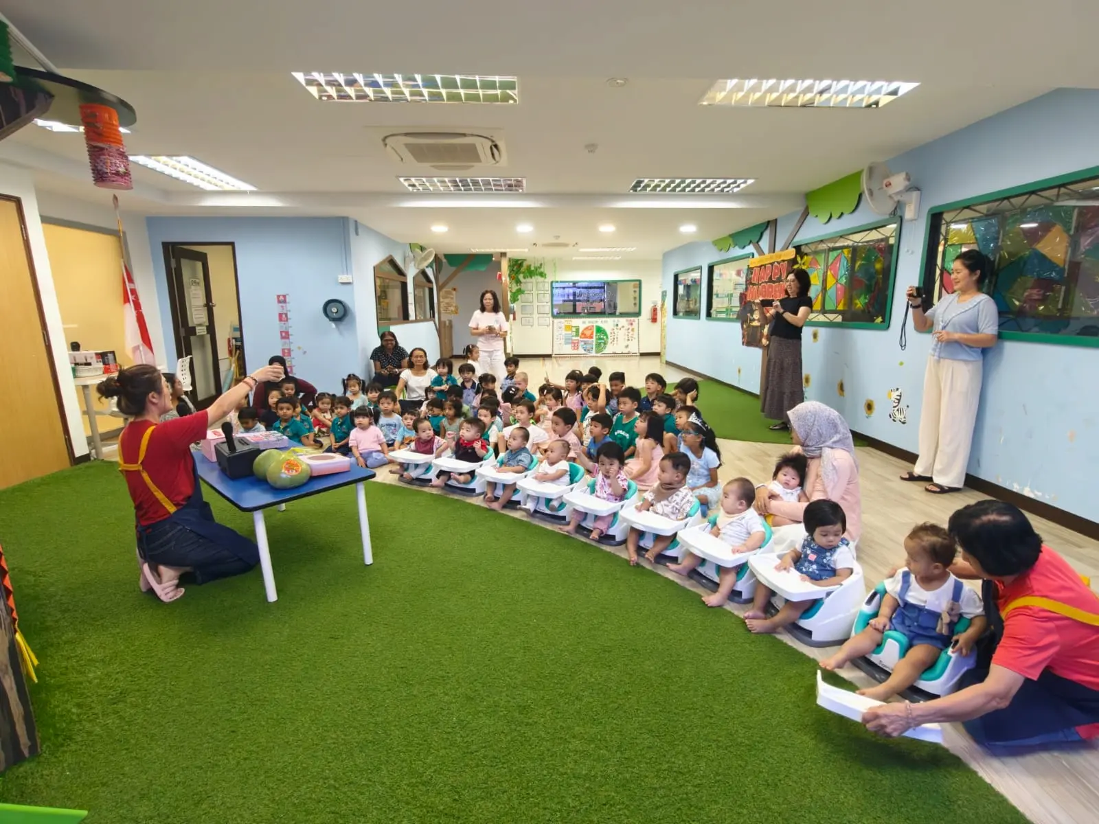 Image of children and teachers in KidsCampus Changi Simei Infant Care